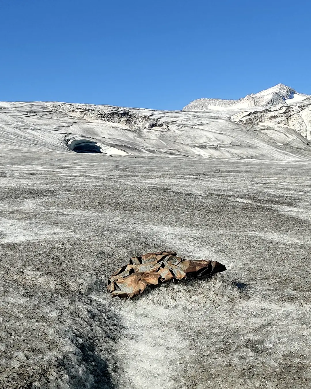 Superficie del ghiacciaio con un detrito metallico arrugginito